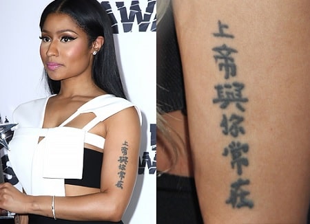 A picture of The Chinese Writing tattoo of Nicki Minaj on her left upper arm.